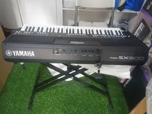 Yamaha Keyboard Sx600 With a Black Keyboard Stand